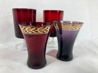 Set Of Red Glasses With Gold Colored Rimmed Red And Purple Glasses