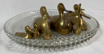 Collection Of Brass Ducks On Crystal Platter