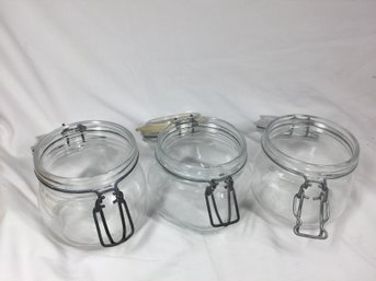 Three Glass Containers With Lids Attached