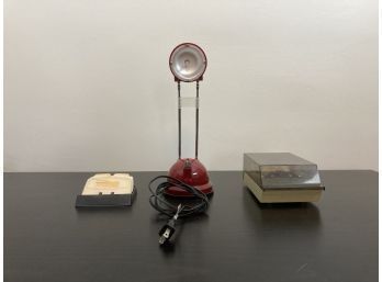 Assortment Of Desktop Tools Featuring Small Maroon Lamp