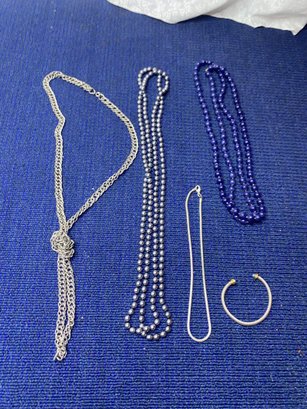 4 Silver And Blue Necklaces And A Bracelet