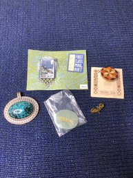3 Pins, A Pendant And A Rock