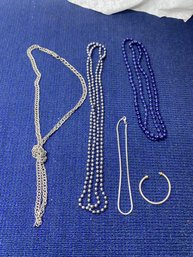 4 Silver And Blue Necklaces And A Bracelet