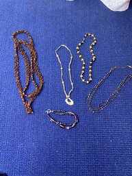 4 Brown Necklaces And A Bracelet