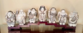 Seven Lucky Gods Of Japan Figurines And A Wooden Platform