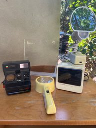 Polaroid 600 Land Camera, Sony Dream Machine, Light Up Magnifying Glass Light Up Mirror And Lucite Stand