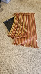 Two Colorful Woven Entry Rugs In Fall Colors Plus A Molded Plastic Boot Caddy