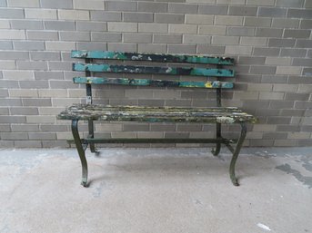 A Garden Bench With Iron Frame And Wooden Slats, Wood Is Worn And Some Losses And With Lichen And Traces Of Ol