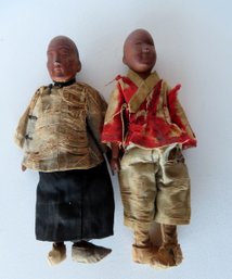 Two Hand Carved Wooden Oriental Dolls In Original Paint And Costumes, 19th Century. The Garments Are Frayed An