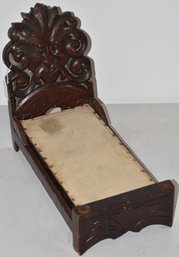CHILDS CARVED WOOD DOLL BED
