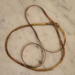 STERLING HERRINGBONE MARKED 925-ITALY-THIN NECKLACE IN GOLDTONE--20'L