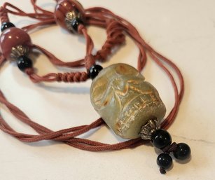 VINTAGE  ASIAN RUST CORD BEADED ADJUSTABLE NECKLACE WITH CARVED PENDANT