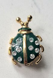 VINTAGE MARKED 'BIJOUX CASCIO' GOLDTONE BEETLE BROOCH WITH GREEN ENAMEL & CLEAR RHINESTONES