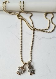 VINTAGE GOLDTONE NECKLACE WITH TWO  CHILDREN PAVE CHARMS---36'L