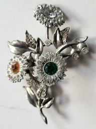 VINTAGE ARTICULATED SILVERTONE FLORAL BROOCH WITH COLORED STONES