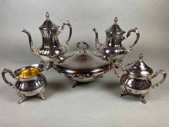 Large Set Of Very Ornate Silverplate Pieces Including Coffee Pots, A Creamer & Sugar, & A Chafing Dish