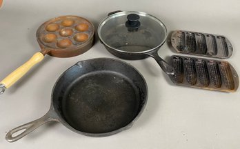 5 Pieces Of Cast Iron Cookware, Including Two Skillets, Cornbread Irons And An Egg Cooker