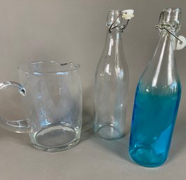 Pair Of Glass Seltzer Or Soda Bottles With Lids And A Clear Glass Pitcher