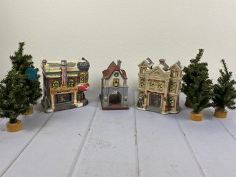 Three Ceramic Or Porcelain Christmas House Figurines Including A Department 56 Gate House & Little Trees
