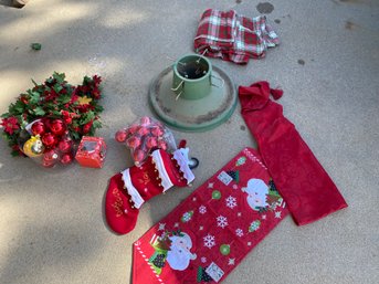 Christmas Tree Stand, Plastic Garland, Red Ornaments, Table Runners, And Stocking For A Good Dog