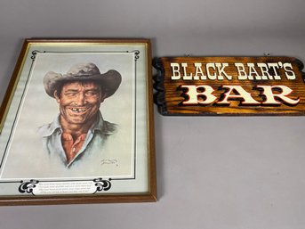 Framed Cowboy Print By Bill Hampton And Wooden Black Bart's Bar Sign