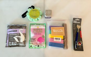 Unused Assortment Of Self Care Items Featuring A Back Scratcher, Bath Salts, Salt Block, Body Scrubber & More