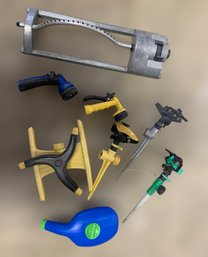 Assortment Of Garden Watering Tools Including Sprinklers And Shower Hose Attachments