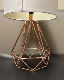 Rose Gold Metal Cage Table Lamp With A Light Cream Shade