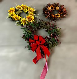 Beautiful Assortment Of Seasonal Wreaths Featuring Sunflowers And A Holiday Wreath