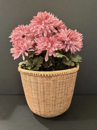 Beautiful Artificial Pink Flowers In A Unique Woven Basket