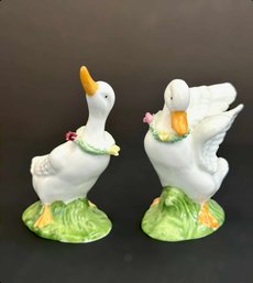 Two Ceramic Omnibus Geese With Floral Wreaths