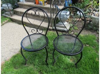 A Pair Of Black Metal Chairs