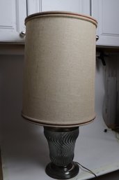 Sophisticated Glass Table Lamp With Silver Tone Accents And Linen Shade