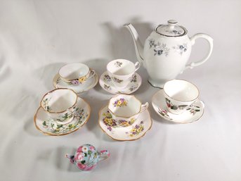 Collection Of Tea Cups With Tea Pot