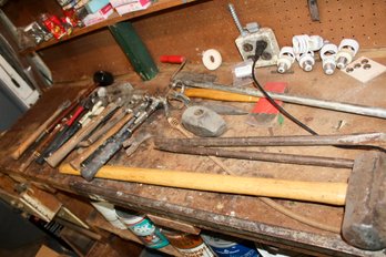 LOT OF TOOLS - VARIOUS SIZED HAMMERS - CROWBARS - SLEDGE HAMMER - HATCHETS - AXES - PIPE AUGER - ITEM#68 BSMT