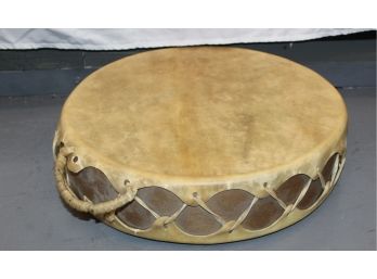 RAW HIDE DRUM WITH RAW HIDE HANDLE - WOOD BASE - 15.5'W X 4'h - GOOD CONDITION - ITEM#83