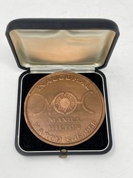 MINT IN BOX AND COLLECTIBLE VINTAGE DELGADO BROTHERS MANILA HILTON 1968 BRONZE COIN
