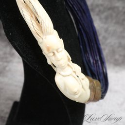 AN EXCEPTIONAL AND RARE LARGE AFRICAN CARVED IVORY COLORED AND NAVY BLUE LEATHER STRAND NECKLACE