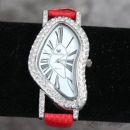 #21 AN EXCEPTIONAL WINDER GEEN CARTIER CRASH STYLE DALI-ESQUE MELTING WATCH WITH CRYSTAL BEZEL AND RED STRAP