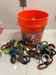 ONE HOME DEPOT BUILDERS BUCKET FULL OF BRAND NEW BUNGEE / PARACORD BRACELETS OR FOR OTHER USES