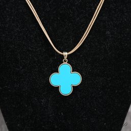 #3 AN ANONYMOUS NECKLACE IN THE STYLE OF VAN CLEEF AND ARPELS DOUBLE SIDED RED AND BLUE ALHAMBRA PENDANT