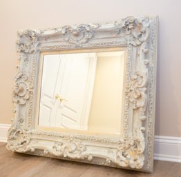 A Rectangular Beveled Mirror In Ornate Antiqued Painted White And Gold Wooden Frame