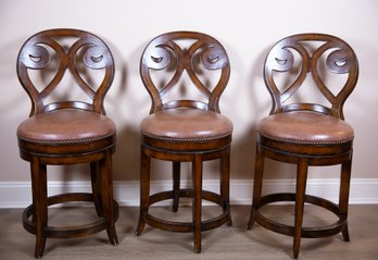 A Set Of Three Bar Stools With Nail Head Leather Upholstery