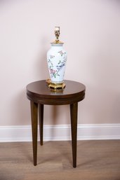 A Circular Mahogany Side Table And Porcelain Lamp