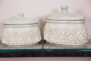 A Pair Of Glazed Terracotta Lidded Vessels