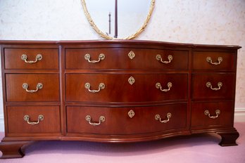 Mahogany Shaped Front Triple Dresser On Bracket Feet