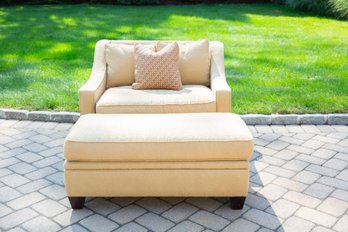 A Pale Yellow Upholstered Seat And A Half Sofa With Ottoman