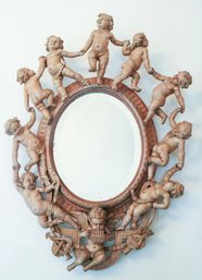 An Italian Carved Wood Cherub Surround Mirror