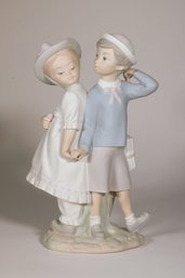 A Lladro Figurine Of A Boy And Girl