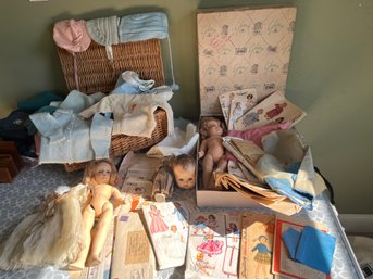 Assorted Vintage And Antique Dolls, Patterns And Basket Of Baby Clothes - A40